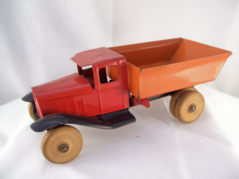 Appraisal: Pressed Steel Dump Truck Original orange red and black paint