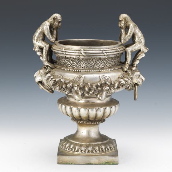 Appraisal: A SILVER METAL ORNATE URN SHAPE COOLER Heavy cast metal