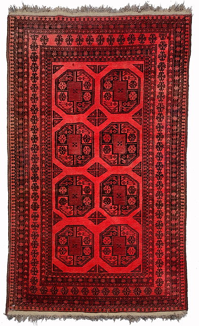 Appraisal: AN AFGHAN WINE GROUND RUG decorated two rows of octagons