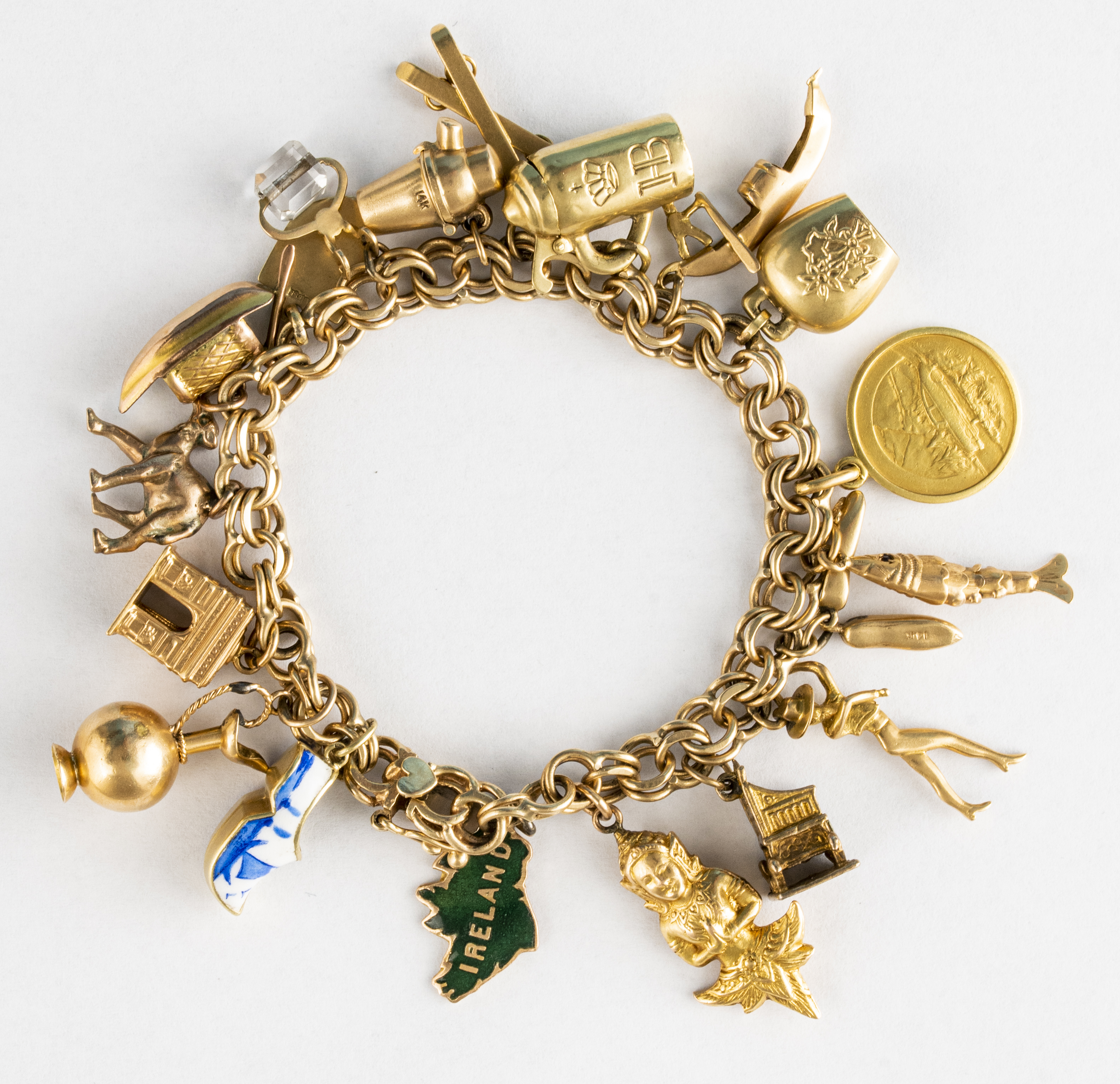 Appraisal: VINTAGE YELLOW GOLD CHARM BRACELET W K COIN Vintage mixed