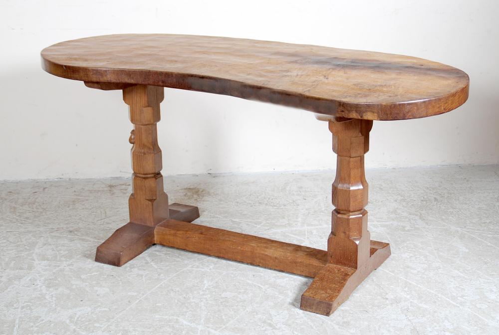 Appraisal: AN ADZED OAK WRITING TABLE by Robert Mouseman Thompson of