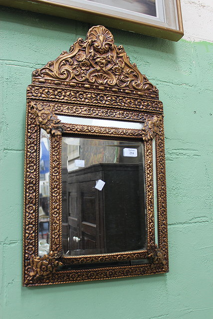 Appraisal: AN OLD GILT METAL CUSHION FRAMED HANGING WALL MIRROR with