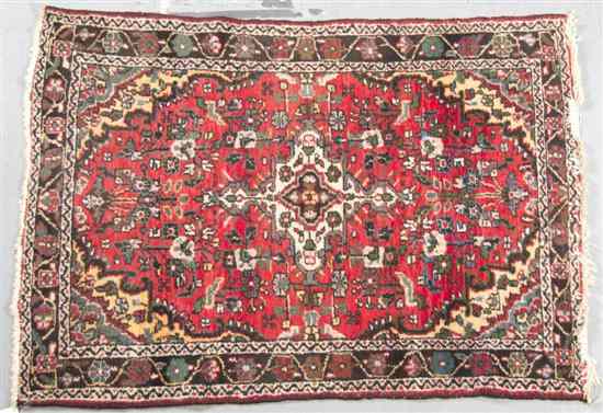 Appraisal: A Northwest Persian Wool Carpet having a stylized foliate center