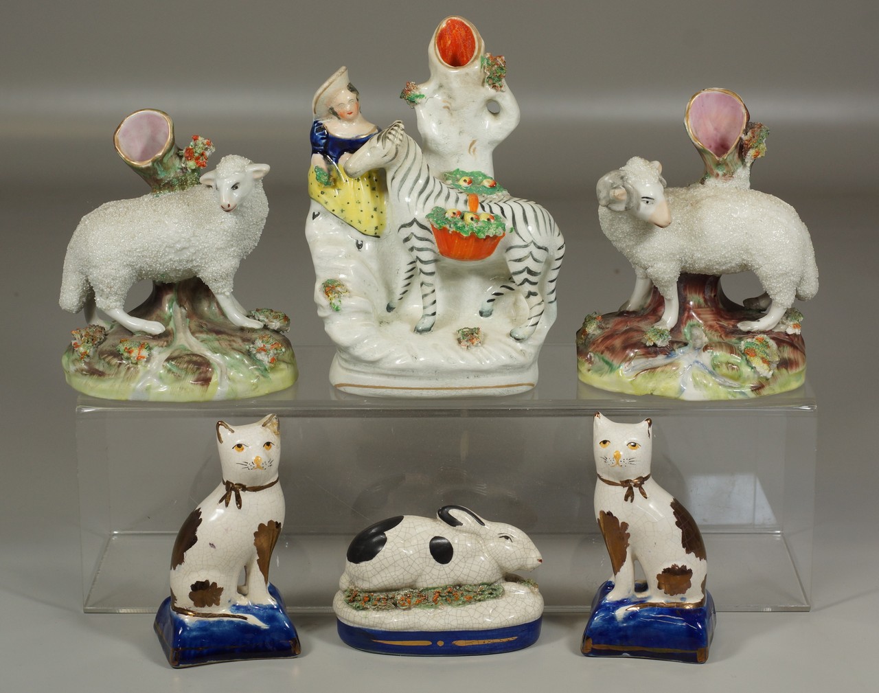 Appraisal: Staffordshire figurines including pair of cats rams zebra rabbit tallest