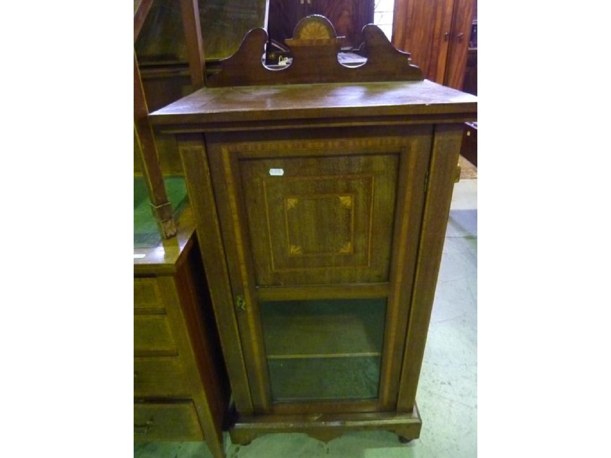 Appraisal: An inlaid Edwardian mahogany music cabinet with cross banded detail