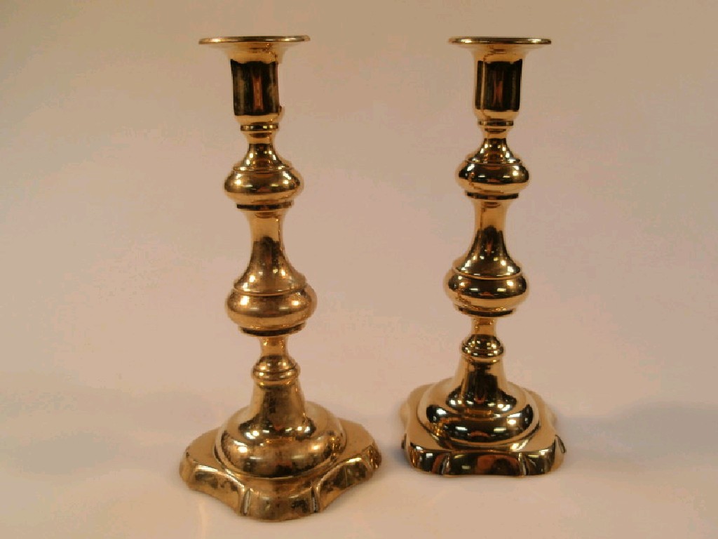 Appraisal: A pair of Victorian brass baluster shaped ejector candlesticks cm