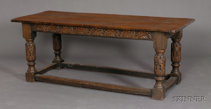 Appraisal: Elizabethan-style Carved Oak Refectory Table rectangular plank top with breadboard