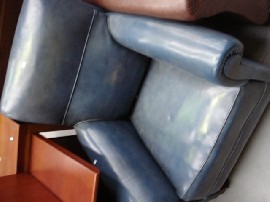 Appraisal: A blue leather upholstered armchair