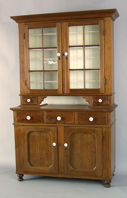 Appraisal: Pennsylvania walnut two part Dutch cupboard th c the molded