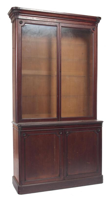 Appraisal: A Victorian mahogany bookcase cabinet the projected moulded cornice over