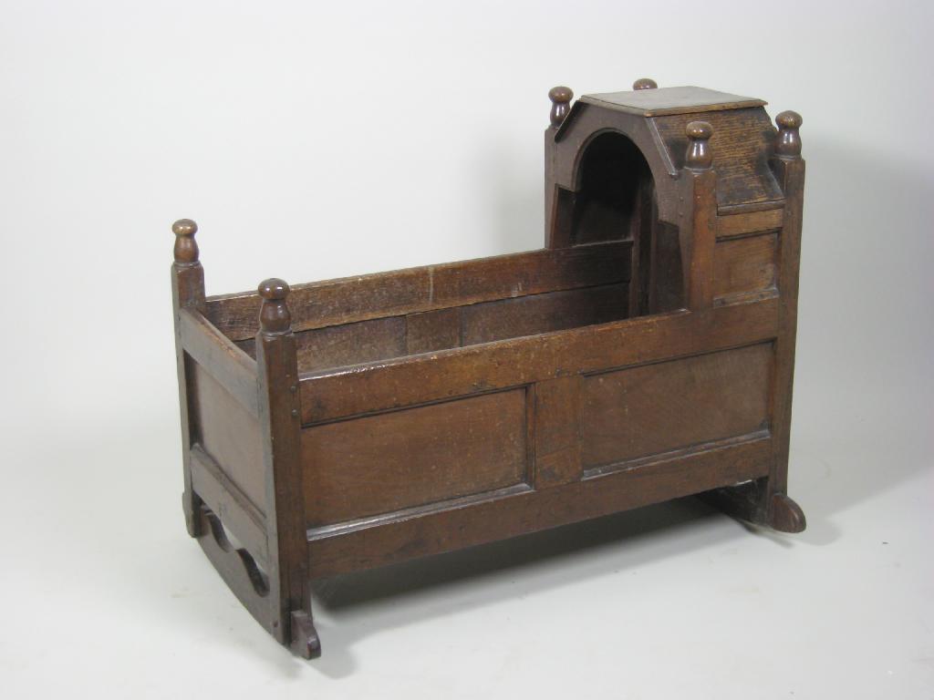 Appraisal: An th Century oak Cradle of panelled construction with hooded