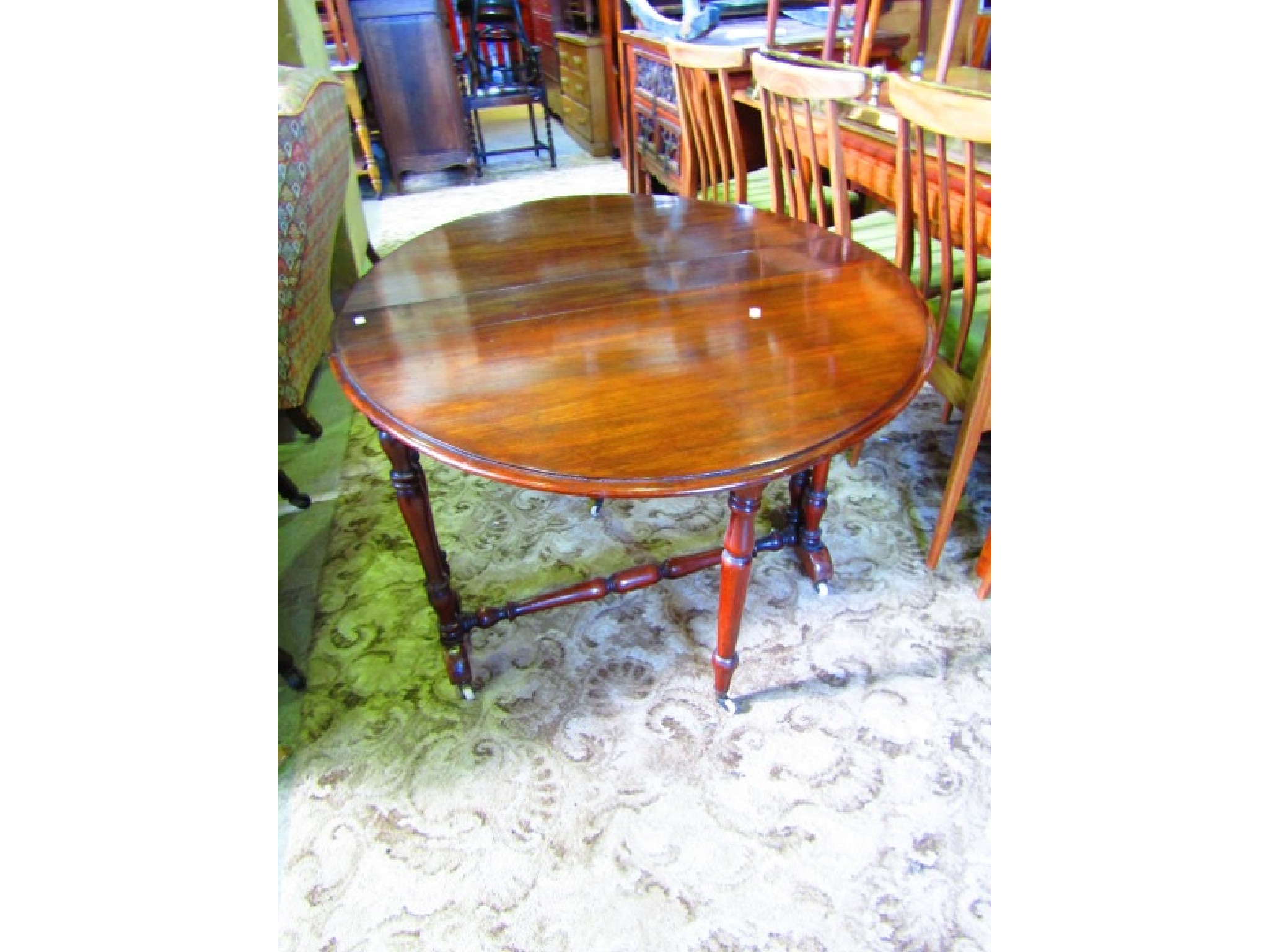 Appraisal: A Victorian walnut Sutherland table with oval moulded drop leaves