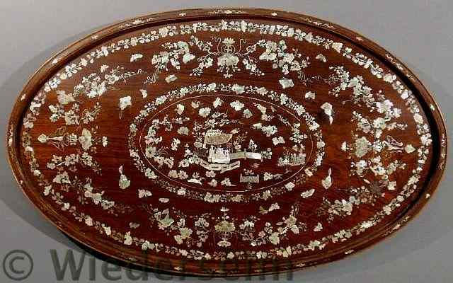 Appraisal: Oval exotic wood tray ate th c with extensive mother-of-pearl