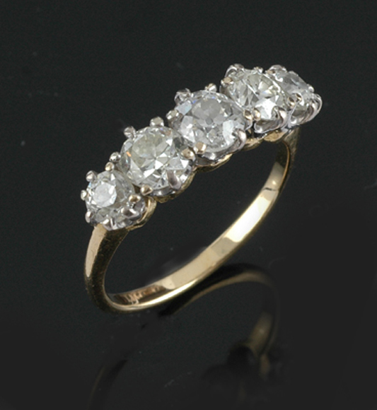 Appraisal: A diamond half hoop ring Claw set with five round