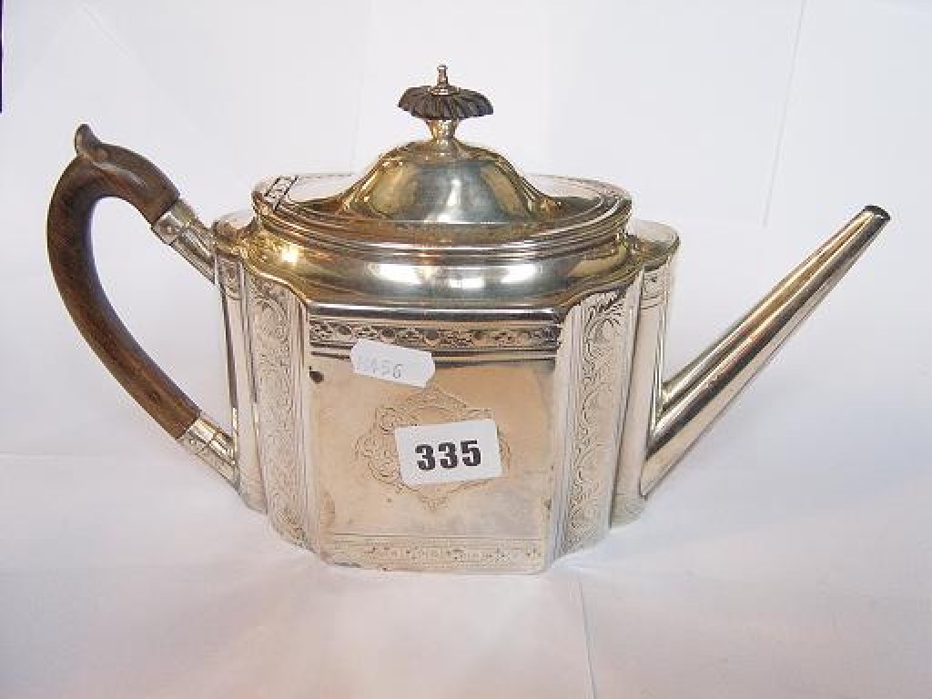 Appraisal: A classical style silver teapot of shaped form with turned