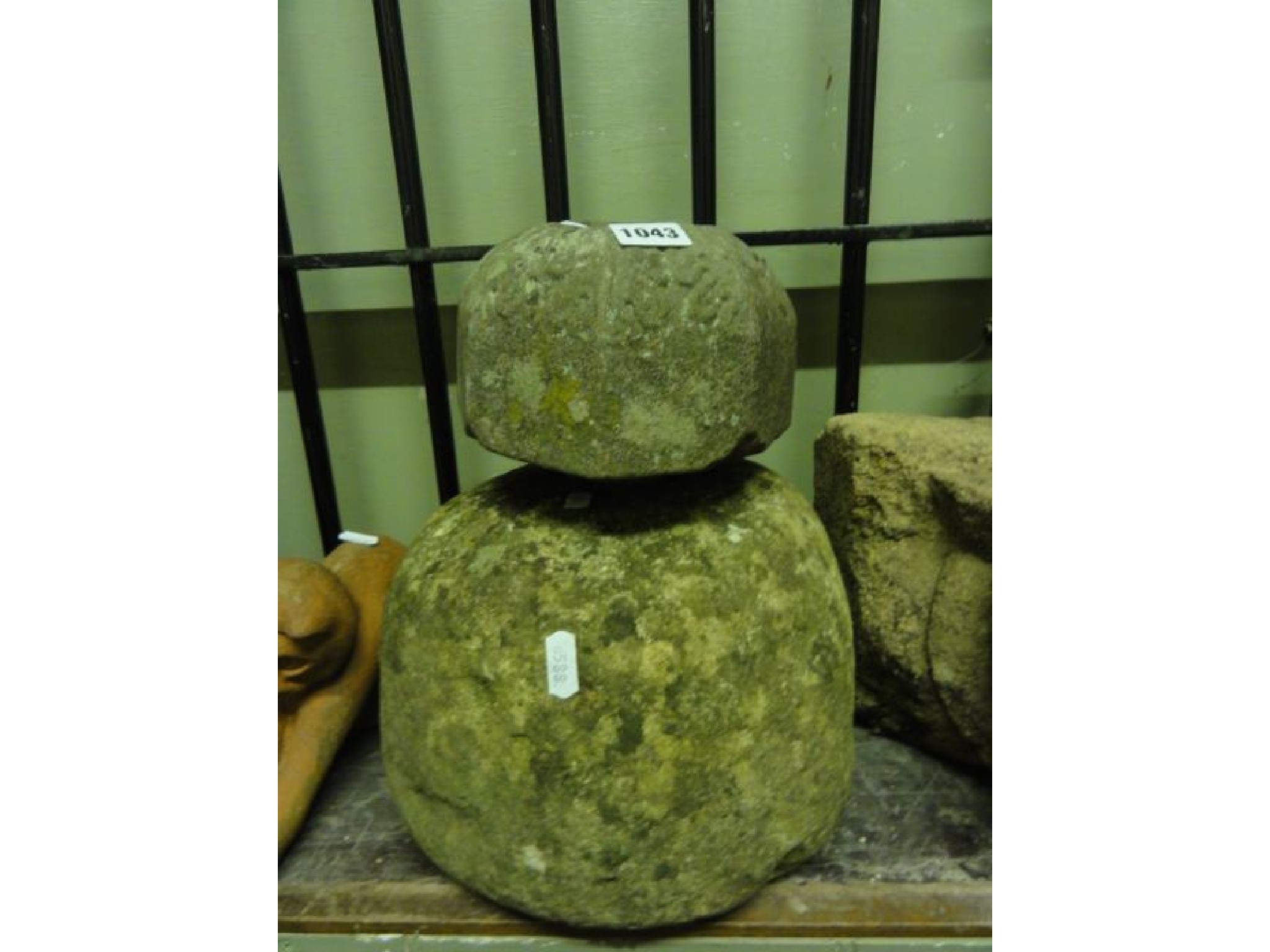 Appraisal: A weathered natural stone mushroom shaped cap finial together with