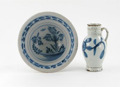 Appraisal: A Delftware bowl and jug the bowl's interior painted with