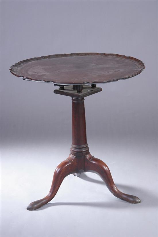 Appraisal: GEORGIAN MAHOGANY TILT-TOP TRIPOD TABLE th century Round serpentine-carved top