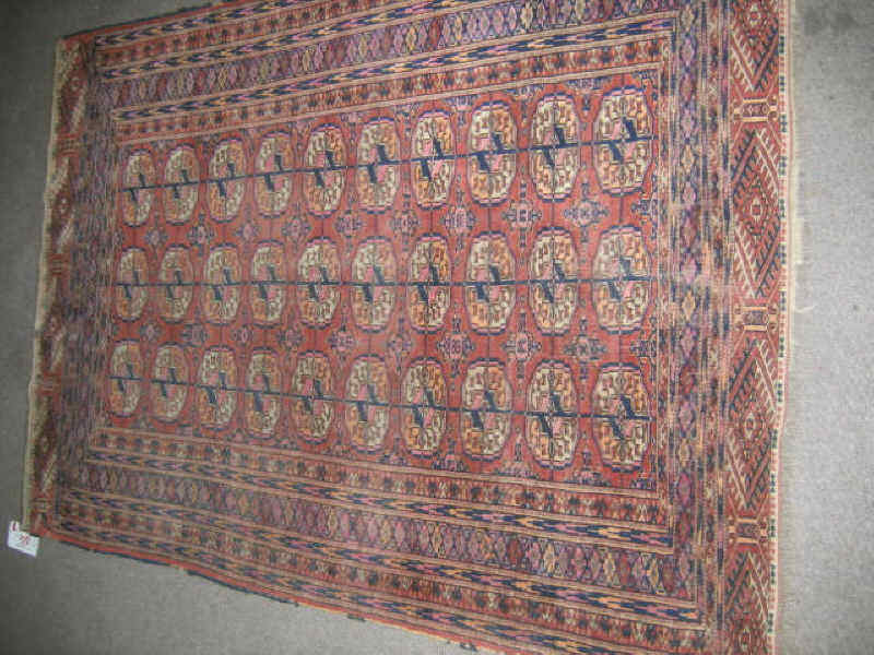 Appraisal: TURKOMAN THROW RUG The salmon field shows an allover geometric