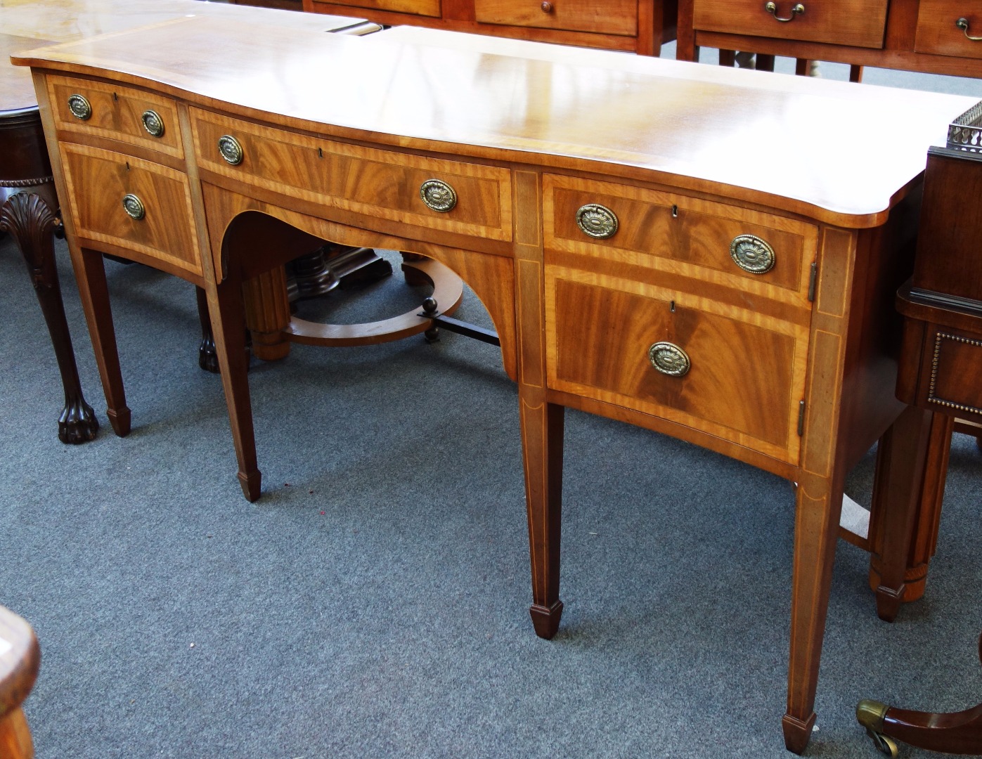 Appraisal: A satinwood and pollard oak banded mahogany serpentine five drawer