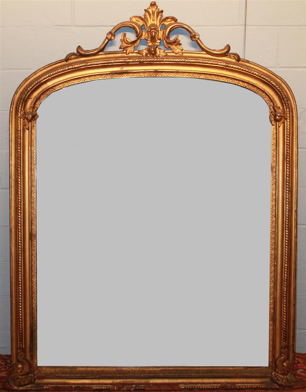 Appraisal: LARGE GILT OVERMANTEL MIRROR having an arching top with pierced