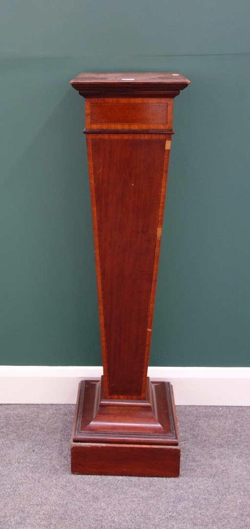 Appraisal: An Edwardian satinwood banded mahogany pedestal with tapering column and