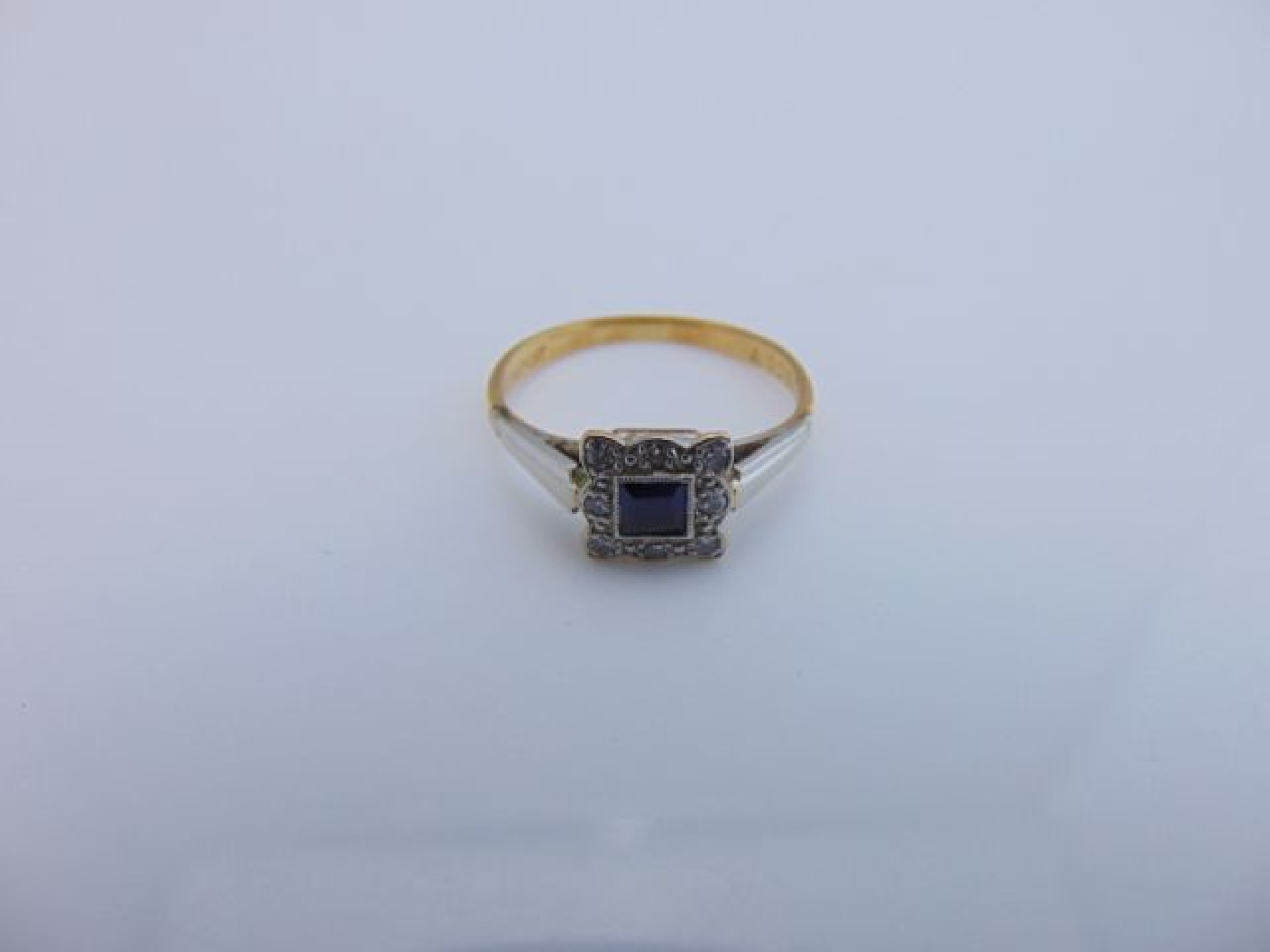 Appraisal: A sapphire and diamond ring centred with a square-cut untested