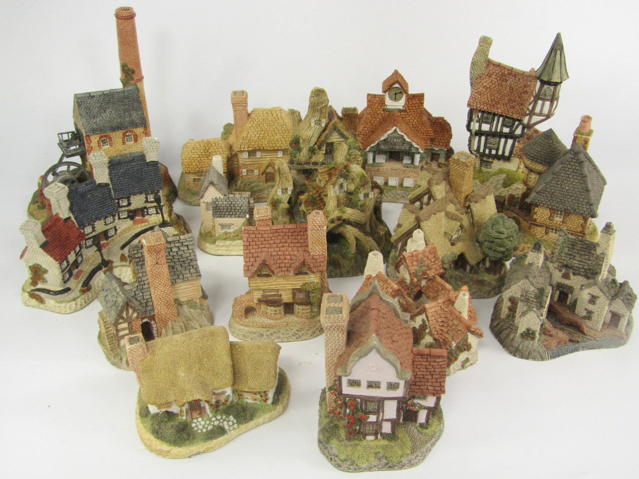 Appraisal: David Winter Cottage sculptures comprising The Woocutter's Cottage Wine Merchant