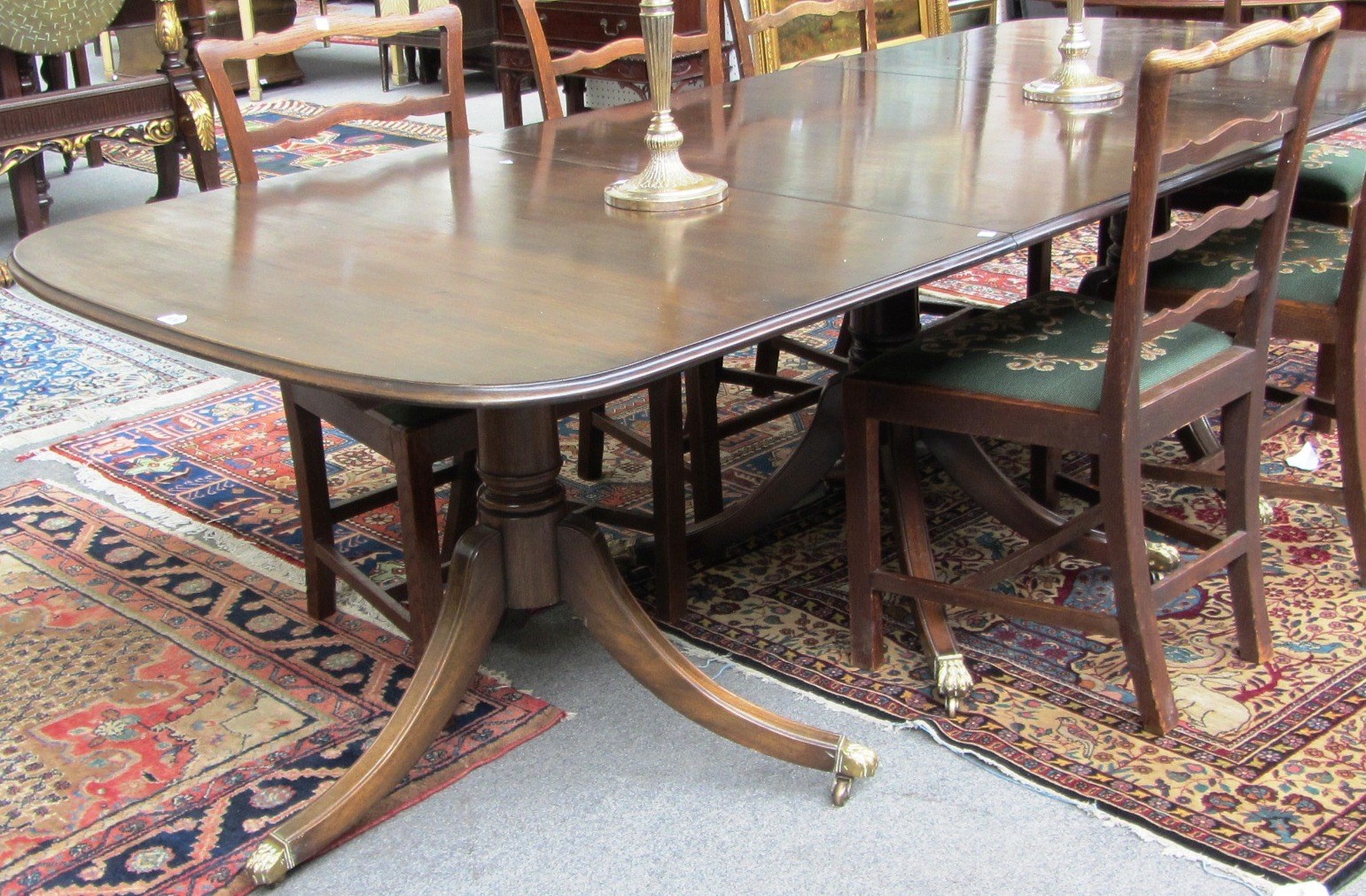 Appraisal: A Regency style mahogany triple pillar 'D' end dining table