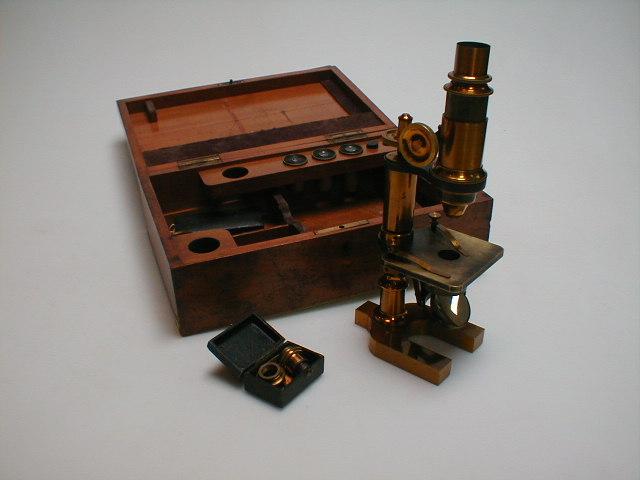 Appraisal: A gilt brass microscope cased with various lenses and a