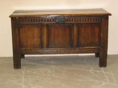 Appraisal: AN OAK PANELLED COFFER the moulded edged plank top with