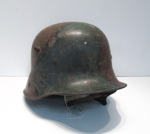 Appraisal: GERMAN MODEL MILITARY HELMET having partial liner exterior painted camouflage