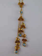 Appraisal: An carat gold blue topaz and diamond floral design pendant