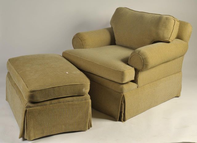 Appraisal: Custom upholstered club chair and ottoman full skirted loose cushions