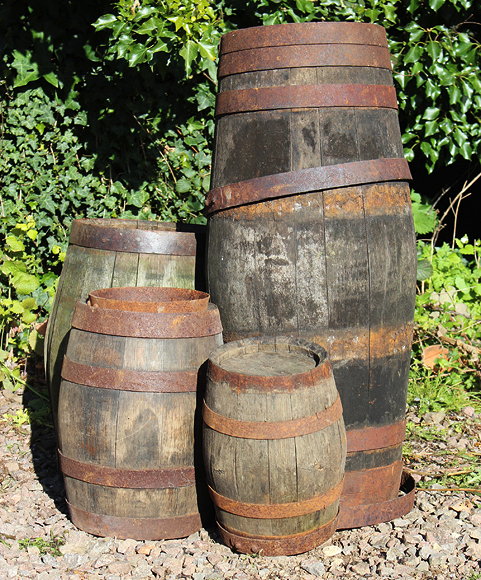 Appraisal: A SET OF FOUR COOPERED BARRELS of assorted sizes the