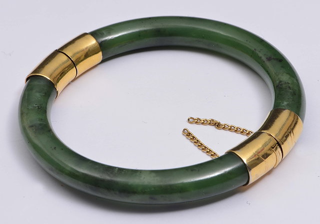 Appraisal: A CHINESE SPINACH GREEN JADE BANGLE with gold hinge and