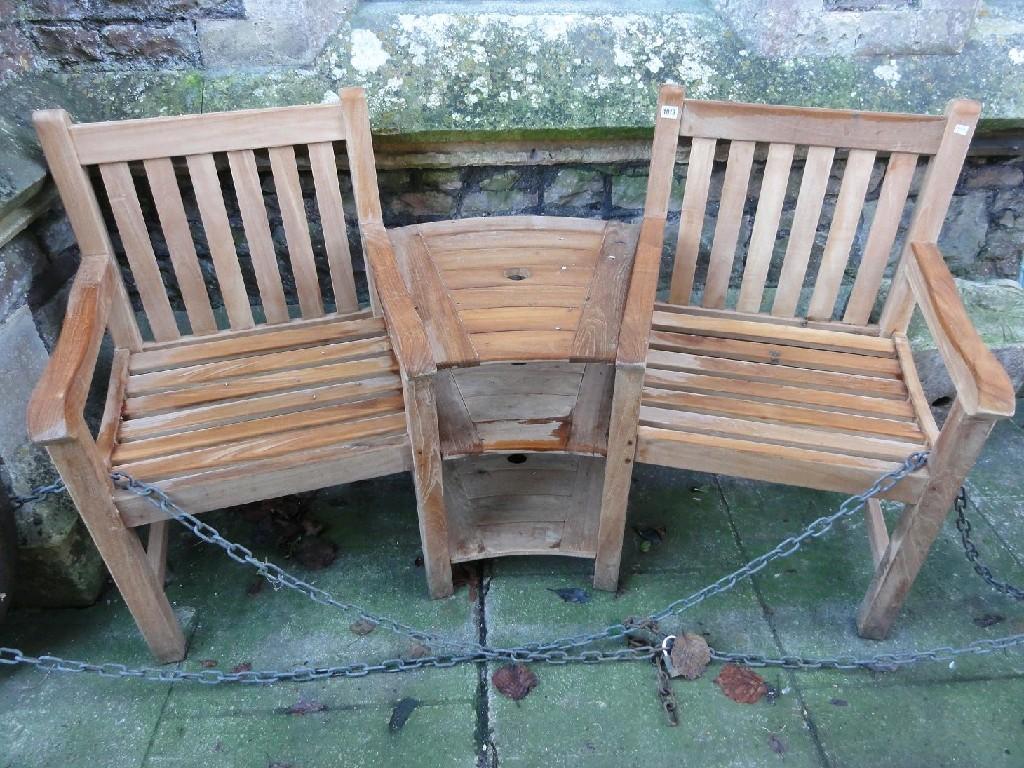 Appraisal: A contemporary teakwood twin garden seat with slatted seats and