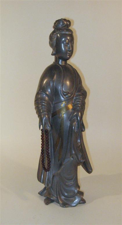 Appraisal: Chinese pewter and gilt metal figure of QuanyinSingle section casting