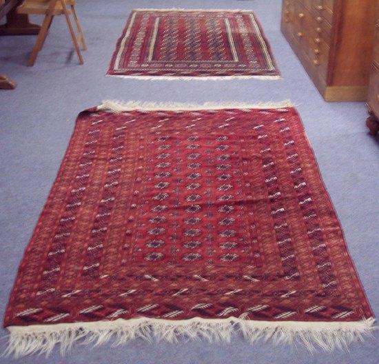 Appraisal: A crimson ground Bokhara rug with thirty elephant foot medallions