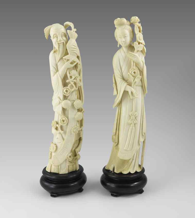 Appraisal: PAIR CARVED IVORY CHINESE FIGURES Figures of a man holding