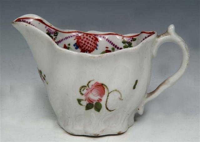 Appraisal: A RELIEF MOULDED CREAM JUG with flower sprig and garland