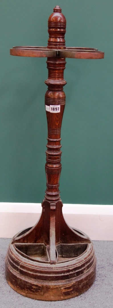 Appraisal: A Victorian oak and metal mounted four division stick stand