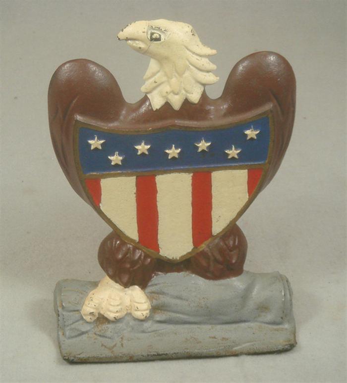 Appraisal: Cast iron doorstop eagle with American crest on grey base