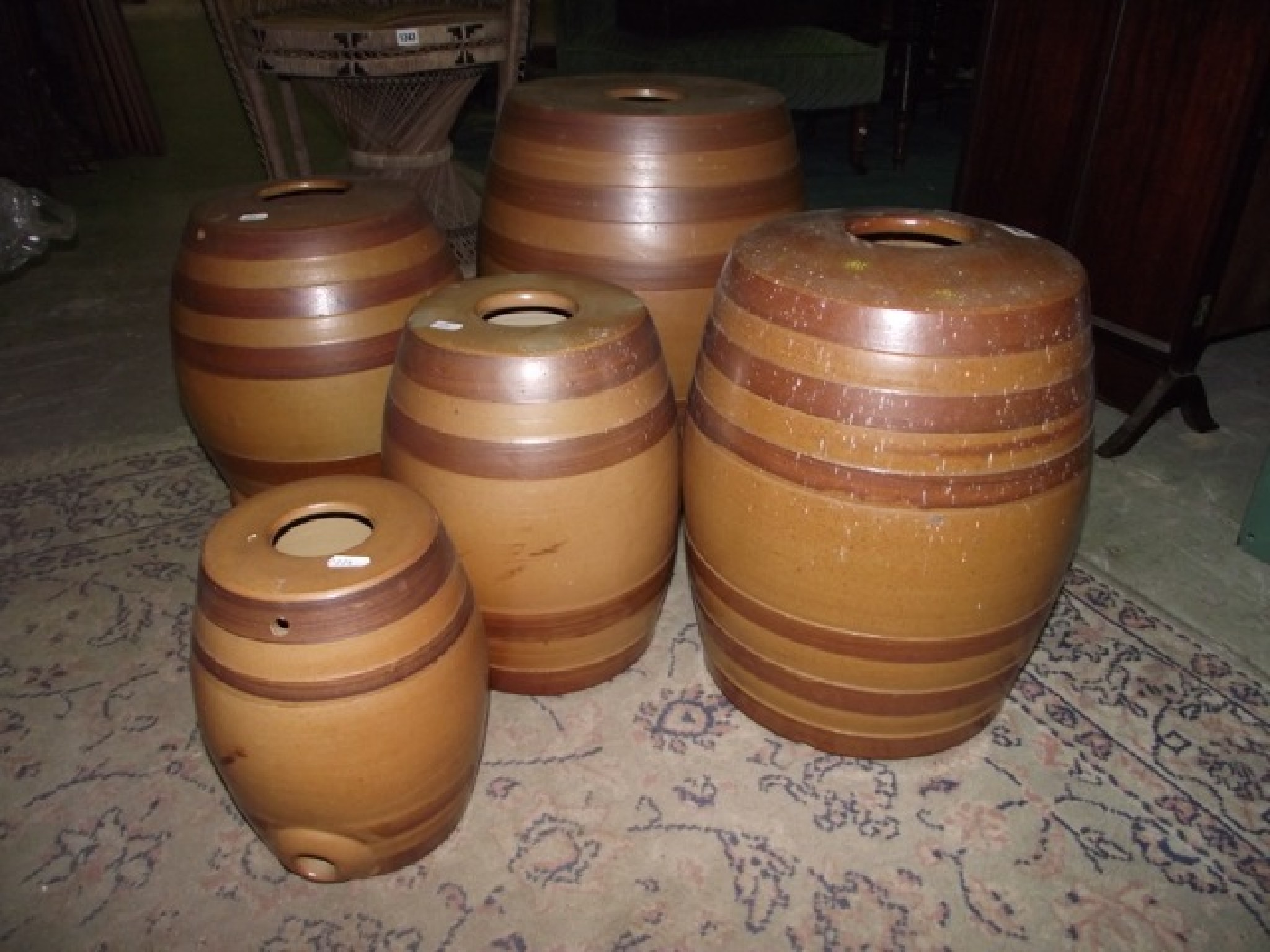 Appraisal: Five vintage treacle glazed stoneware barrels of graduated size with