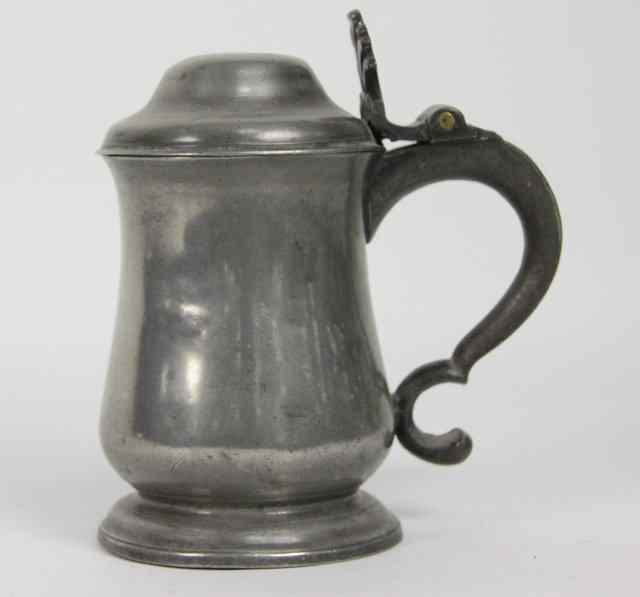 Appraisal: An English pewter pear shaped open dome lidded tankard th