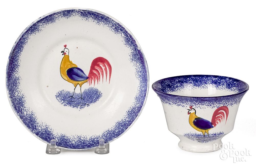 Appraisal: Blue spatter rooster cup and saucer Blue spatter rooster cup