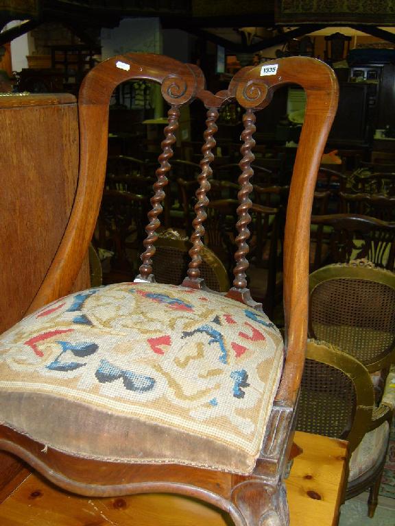 Appraisal: A Victorian rosewood occasional chair with stylised back with spiral