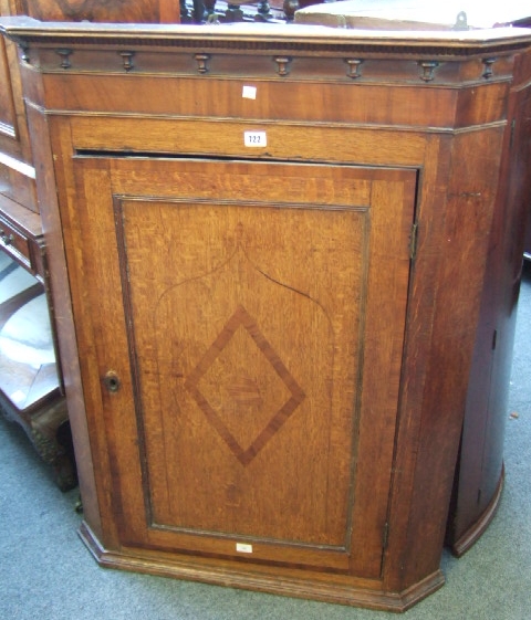 Appraisal: A th century oak hanging corner cupboard the split bobbin