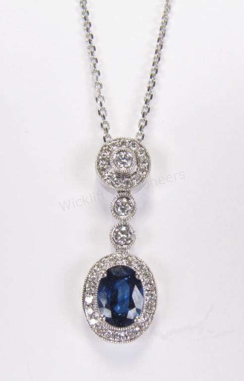 Appraisal: A K white gold dangle pendant featuring an oval sapphire