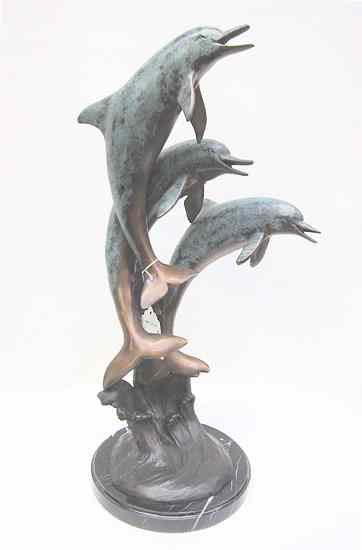 Appraisal: POLYCHROME BRONZE WILDLIFE SCULPTURE depicting three playful dolphins leaping out